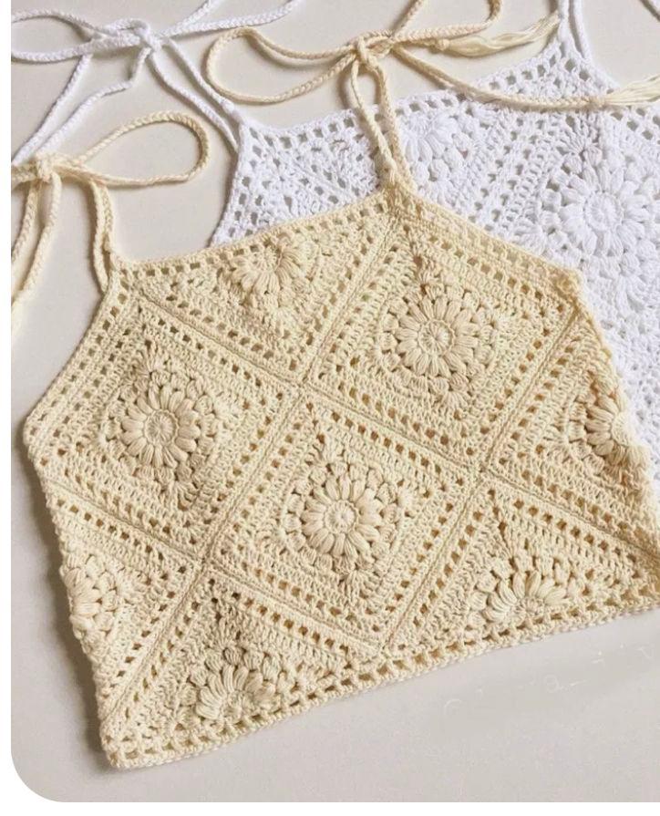 Cream crochet halter top with raised floral square motifs and tie straps.