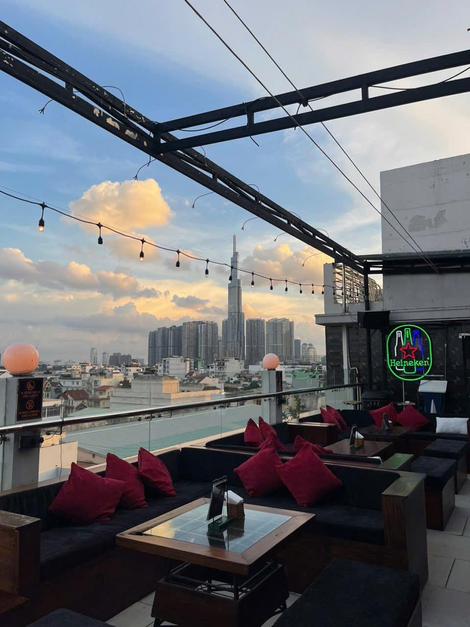 Sunset rooftop seating with city skyline views