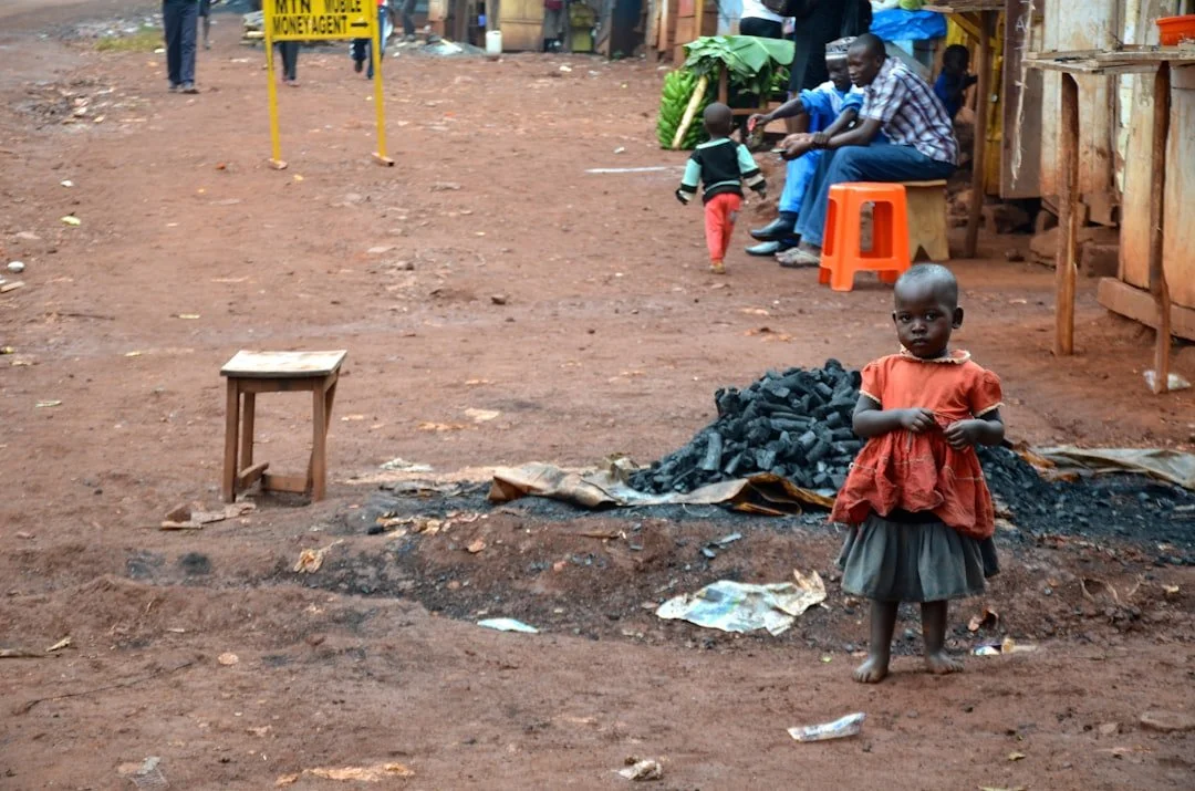A child standing in a village marketplace