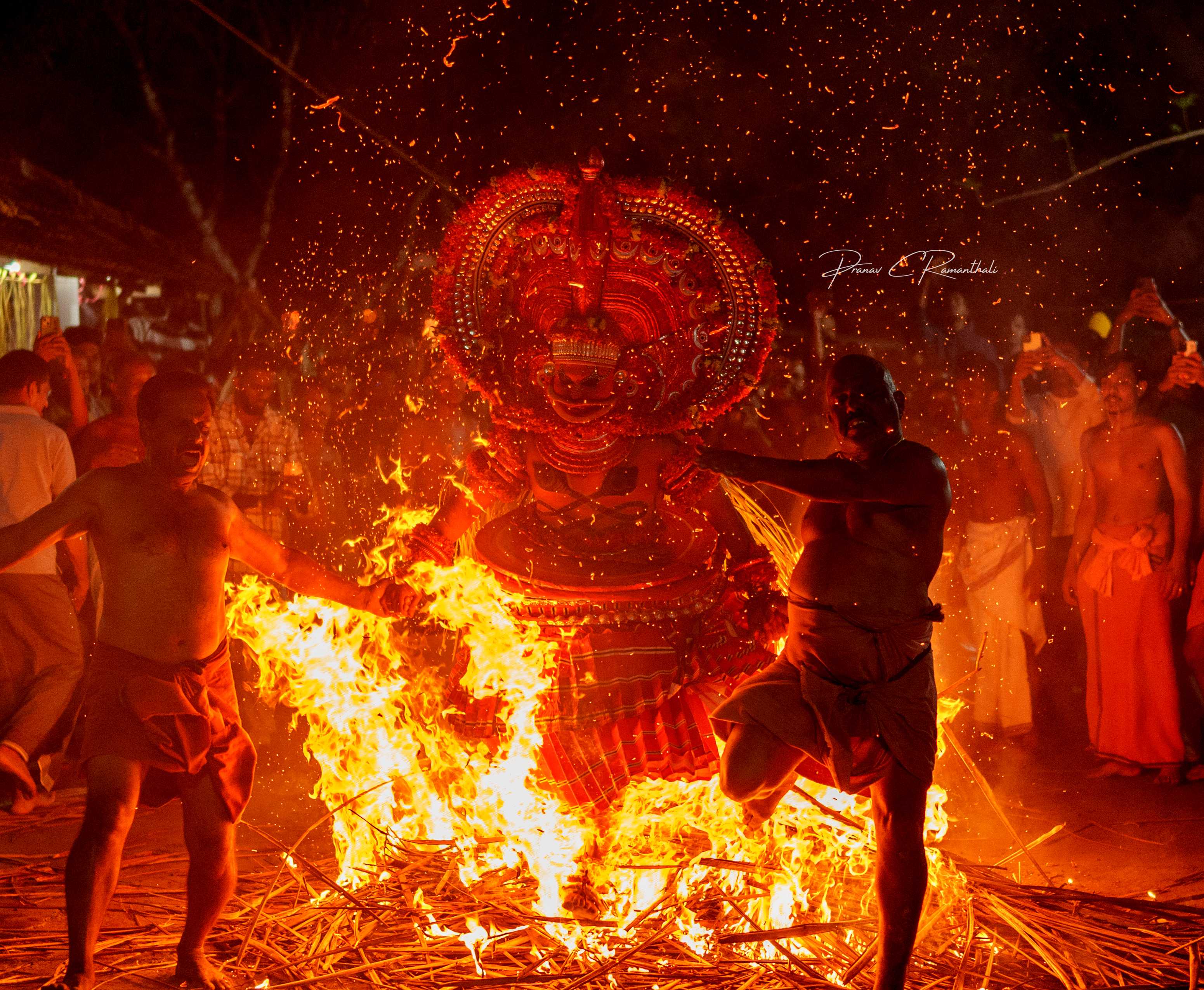 Dynamic Theyyam fire ritual with devotees