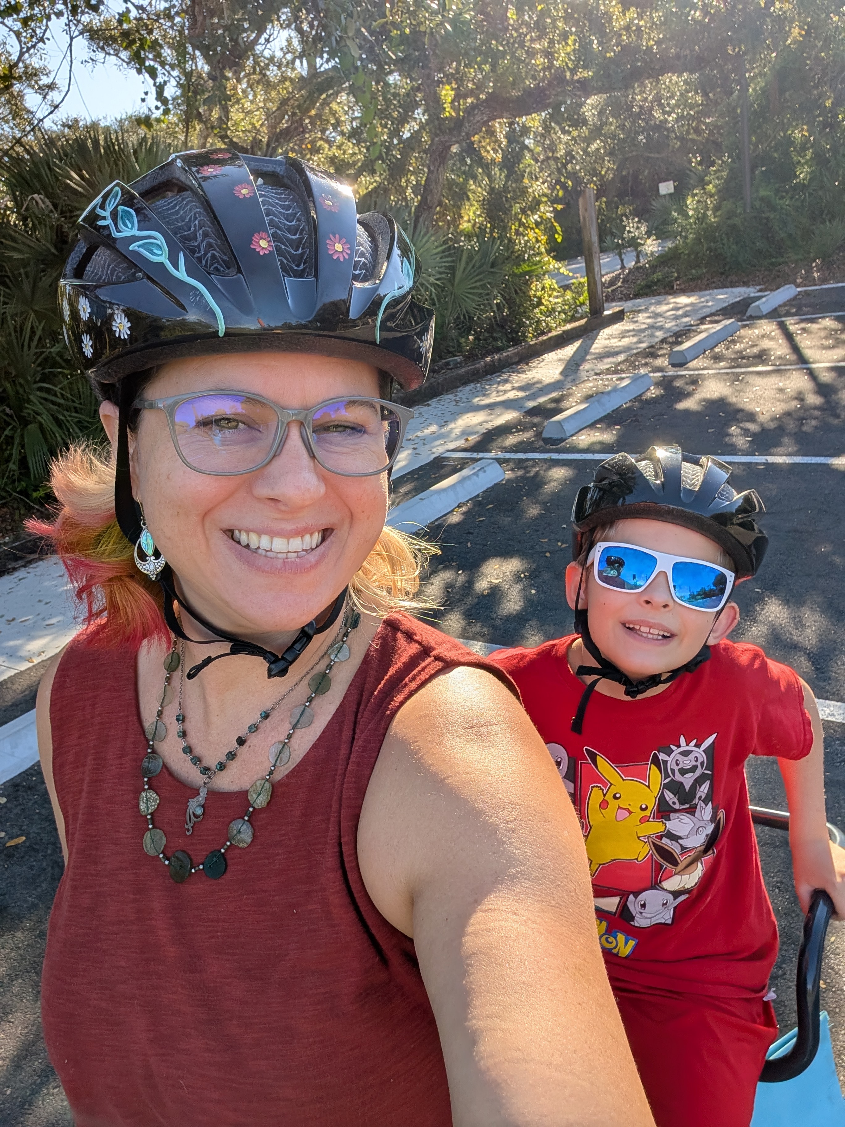 Rae and child enjoying a bike ride together on a sunny trail