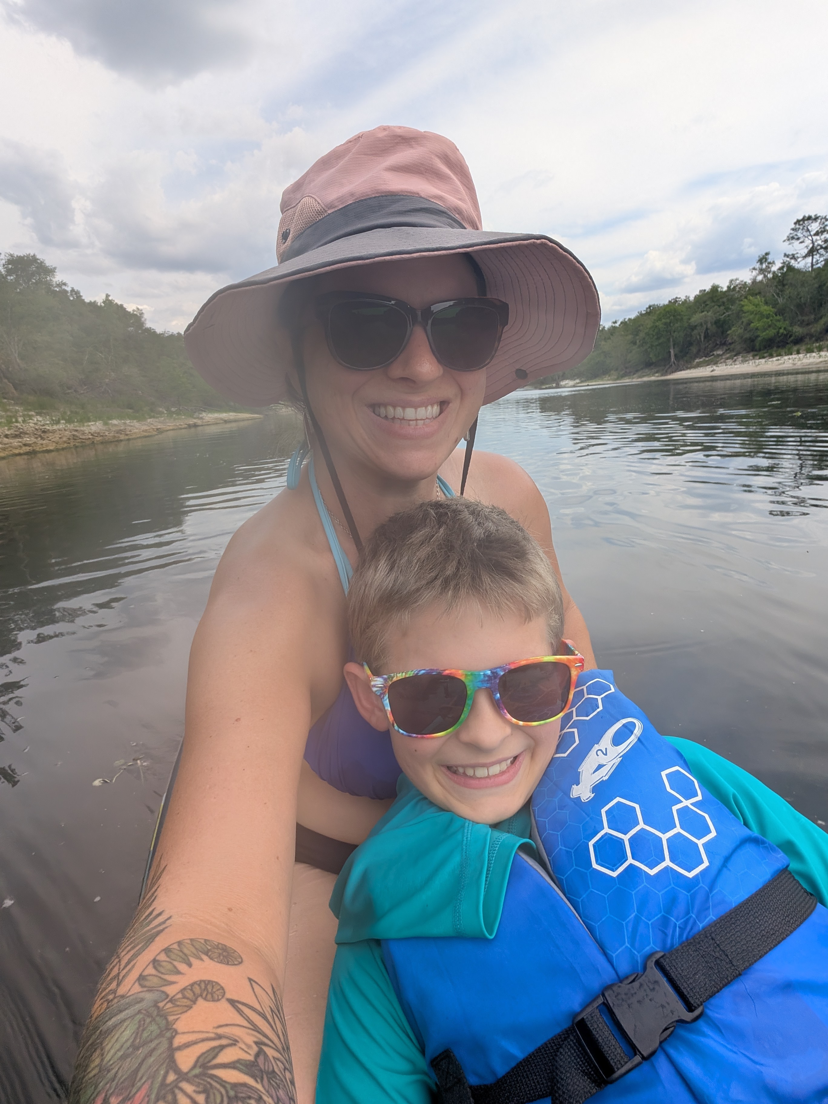 Rae and child swimming together in a river