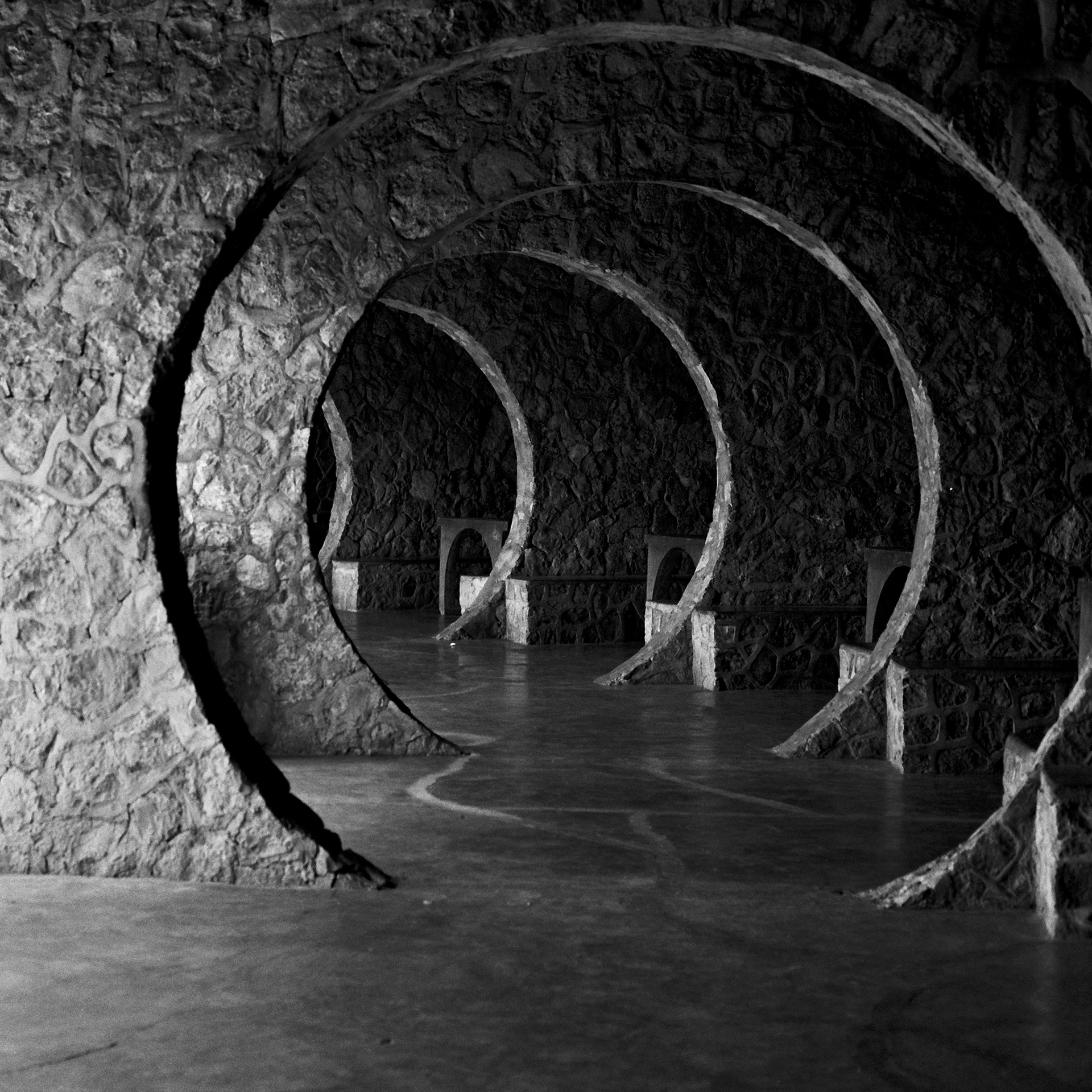 Large circular concrete tunnel structure with concentric rings and flowing water inside