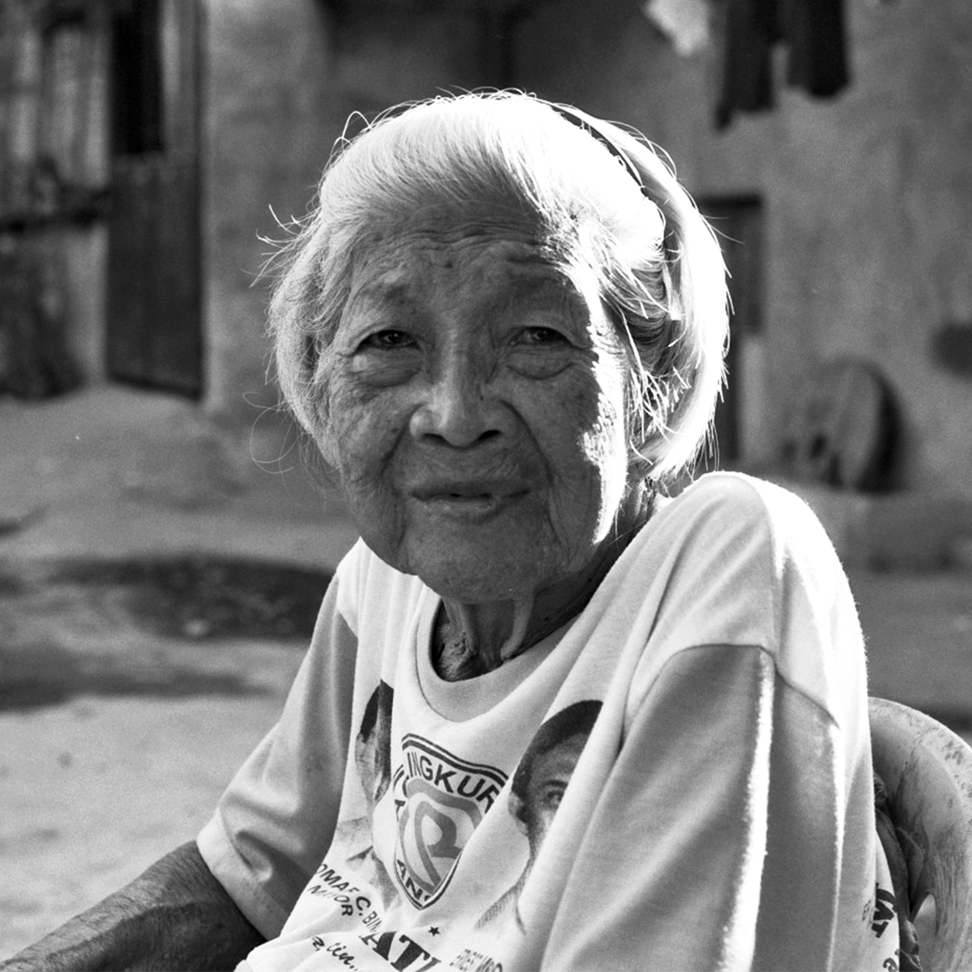 Portrait of elderly woman with white hair wearing light colored shirt