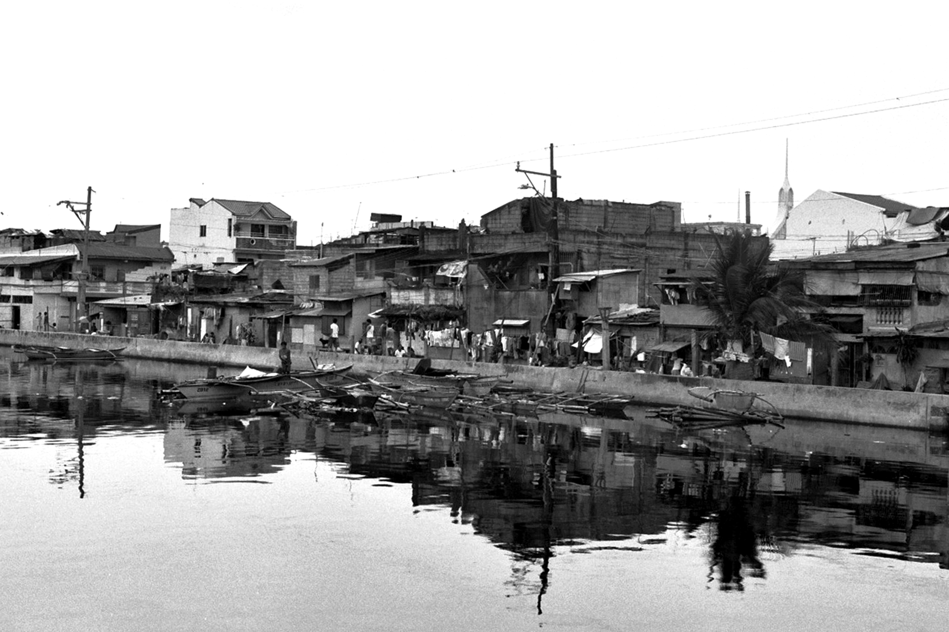Waterfront settlement with buildings reflected in calm water
