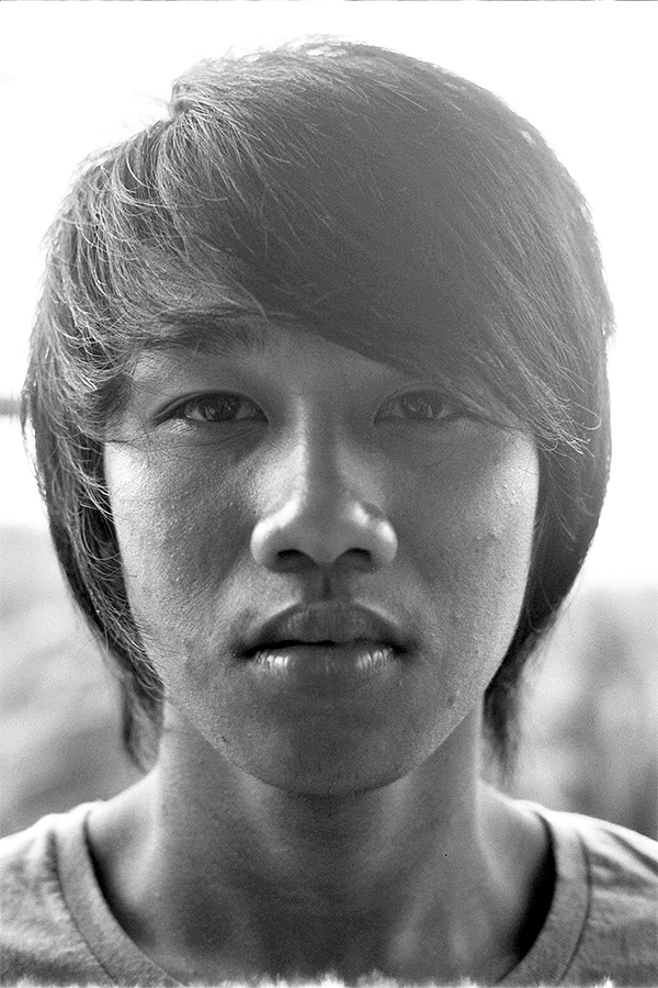 Black and white portrait of young man with distinctive styled dark hair