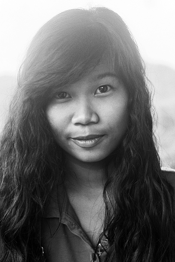 Black and white portrait of woman with long dark hair and warm smile