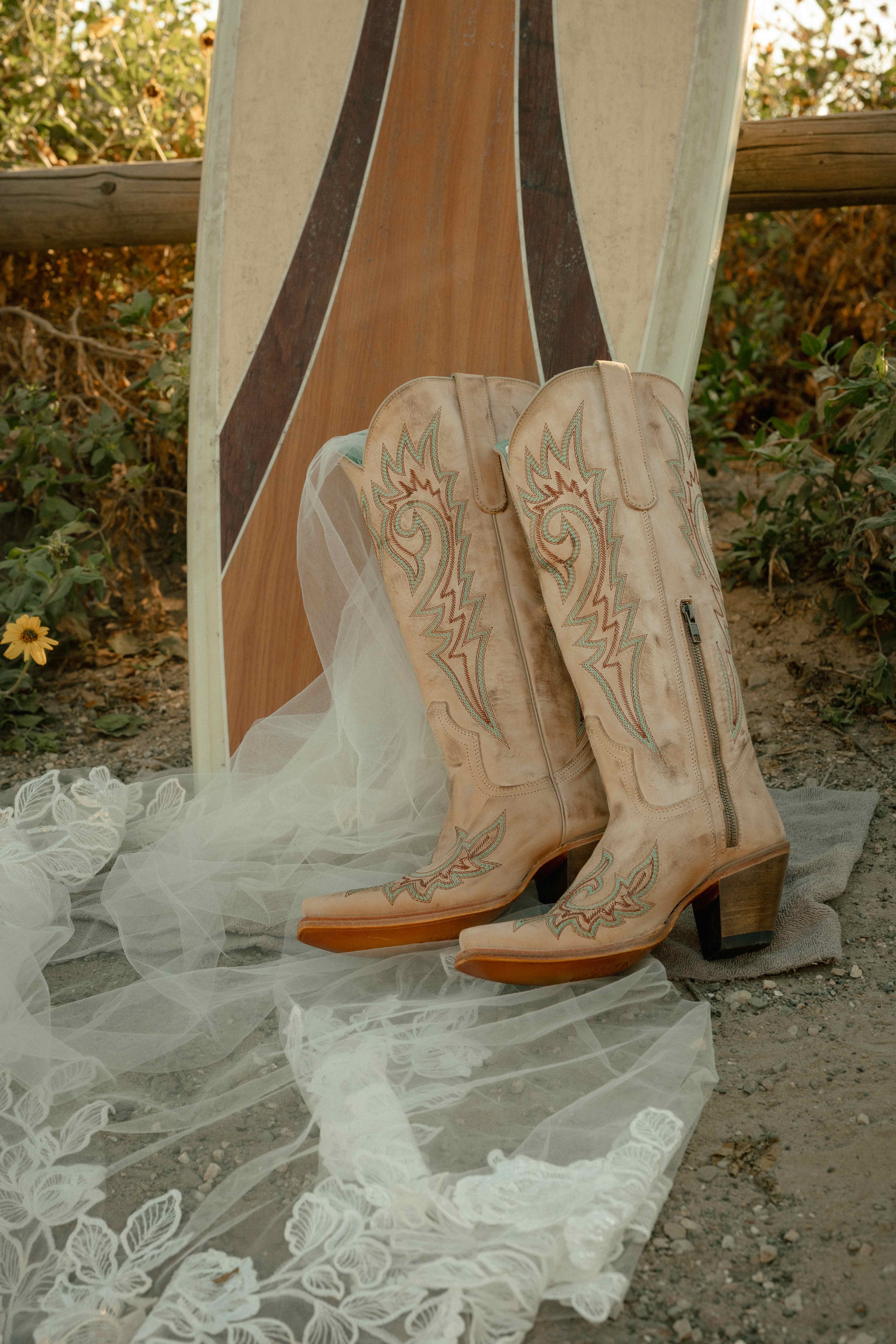 Cowboy boots with surfboard and lace veil