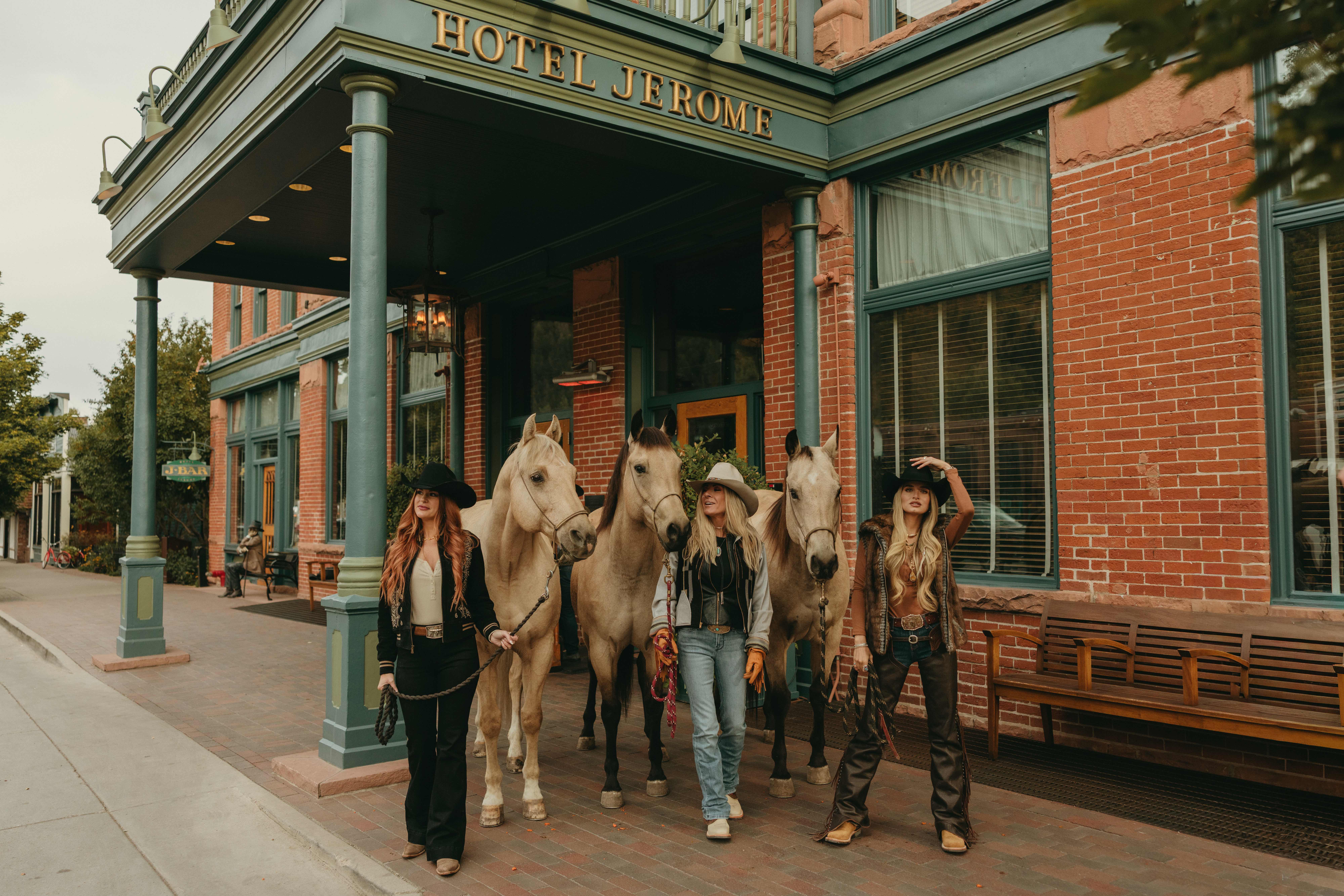 Three cowgirls with palomino horses in front of Hotel Jerome - western luxury