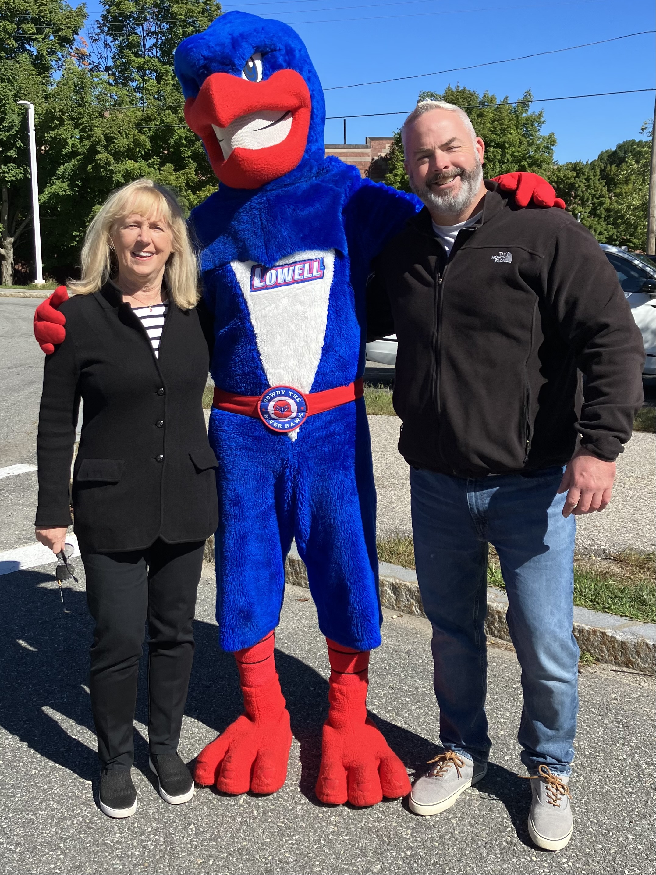 Karla Miller with UMass Lowell River Hawk mascot at community event