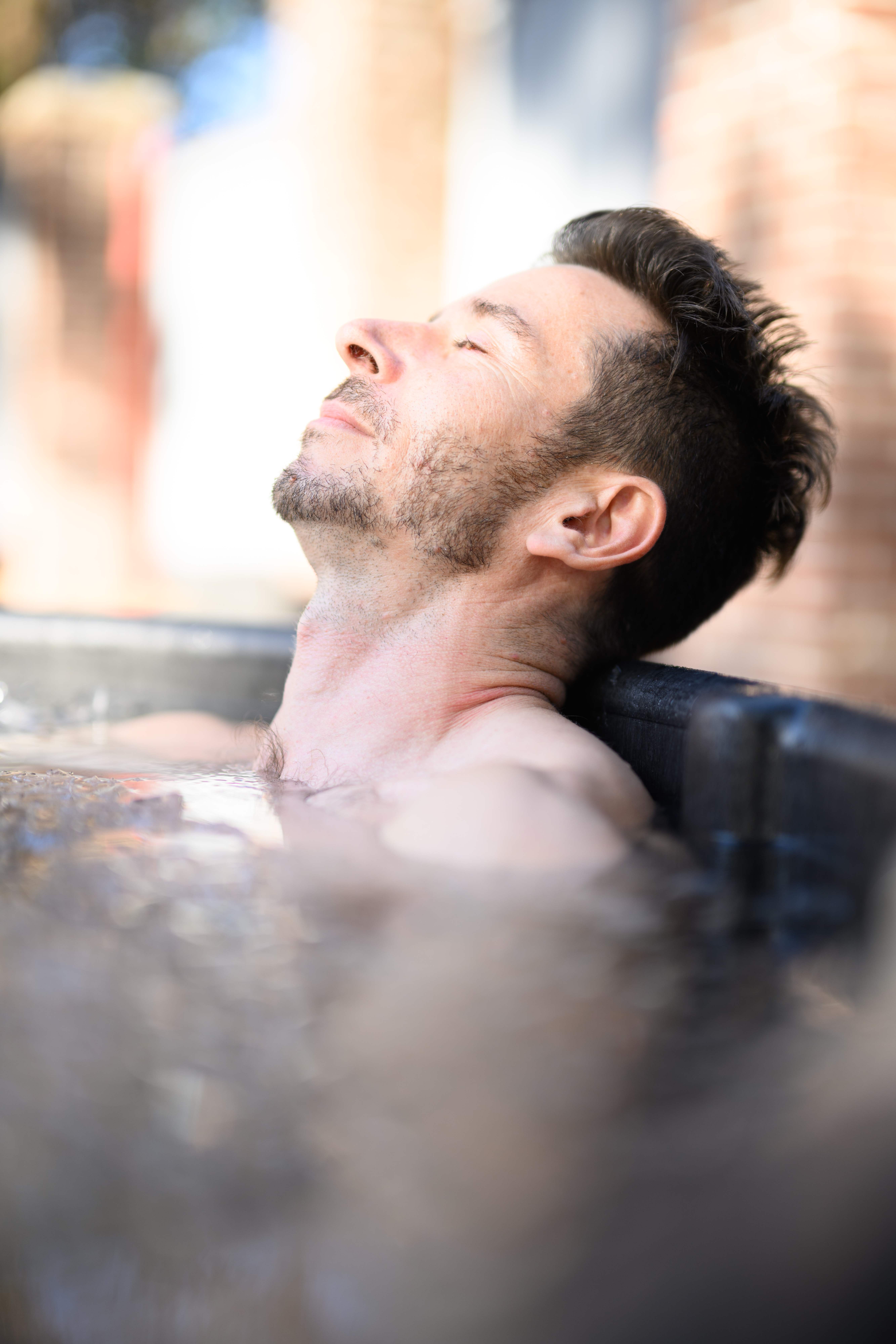 David in ice bath, head tilted back