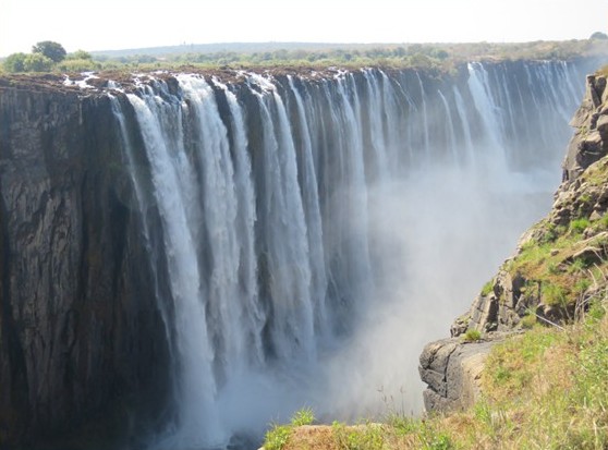 Victoria Falls close-up view with massive cascading water and mist rising from the gorge