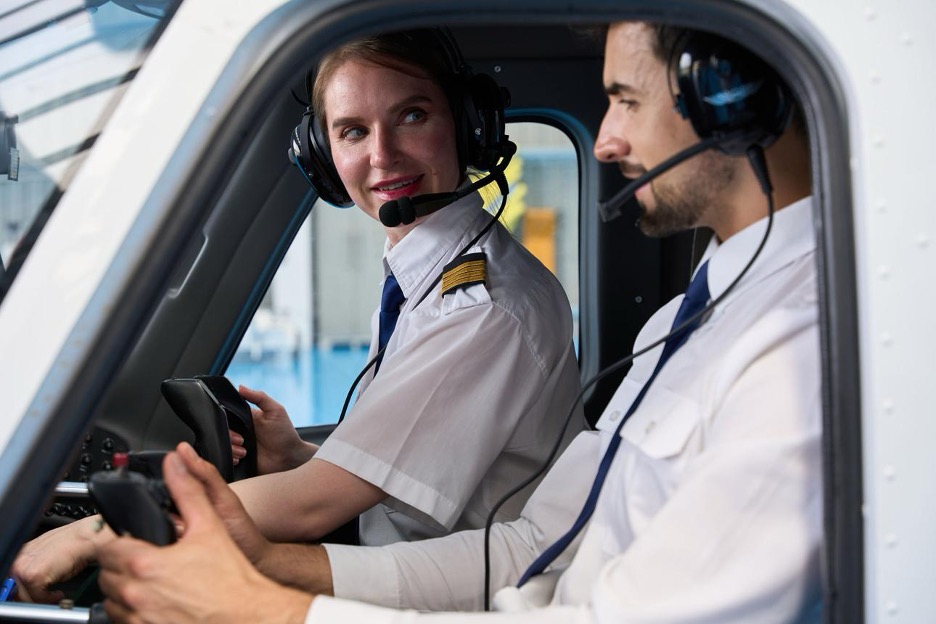 A female airline captain and male first officer flying together in a commercial cockpit.