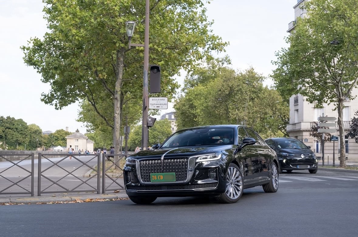 Plaque 26 CD — Chine, corps diplomatique (Hongqi H9, Paris) Plaque diplomatique verte 26 CD sur une Hongqi H9 noire traversant le boulevard de la Tour-Maubourg à Paris — code 26 correspondant à la Chine