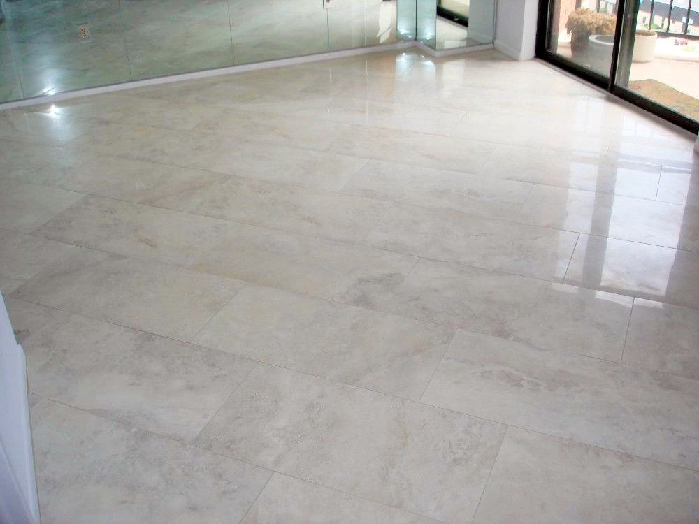 Polished Calacatta marble floor with large format tiles, natural grey veining, and seamless installation