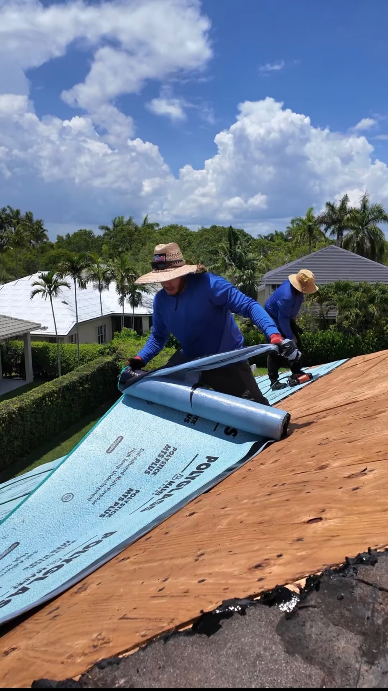 Roofing technician installing materials on residential roof