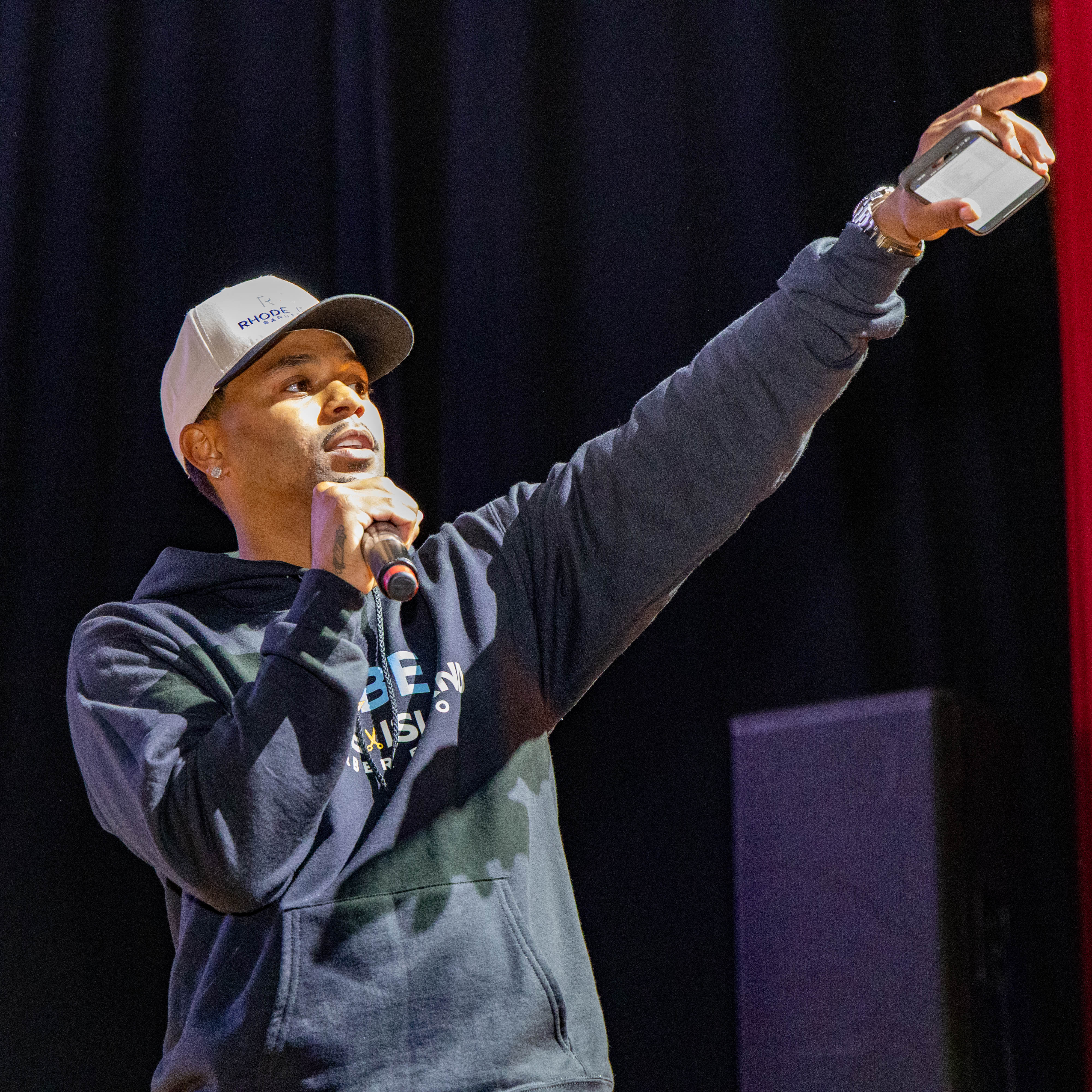 Host speaking on stage at Rhode Island Barber Expo