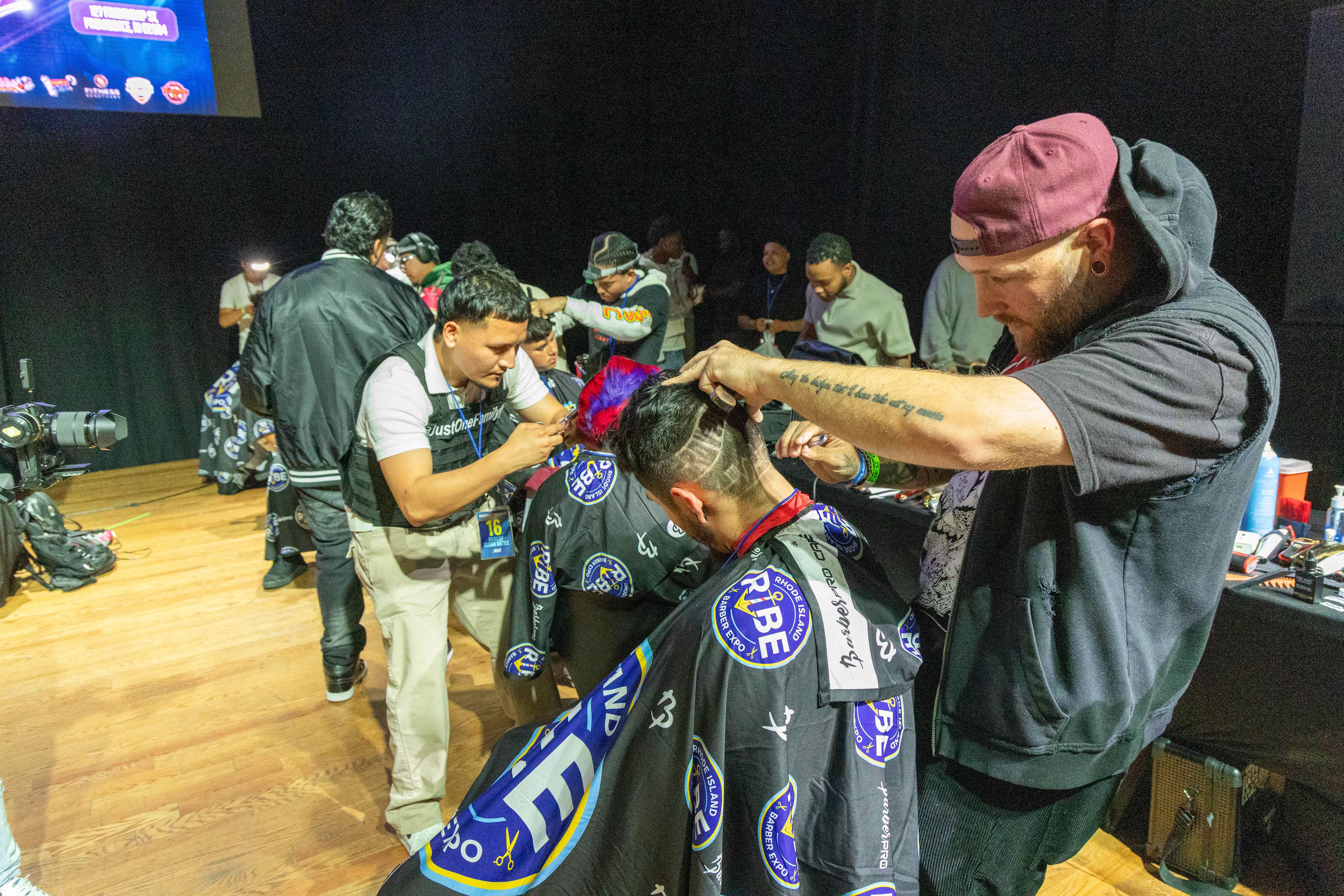 Barbers competing in haircut competition on stage