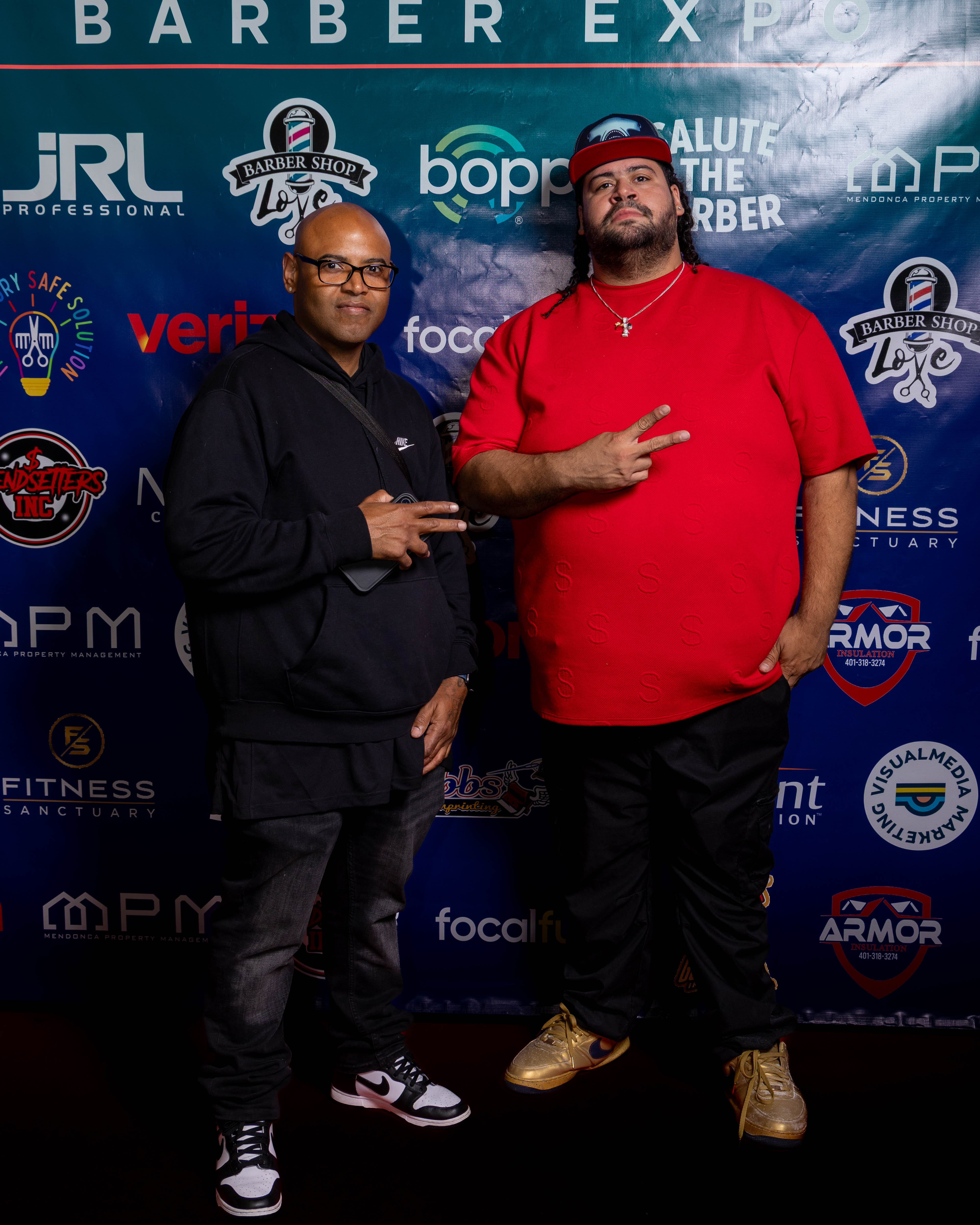Attendees posing at step and repeat backdrop