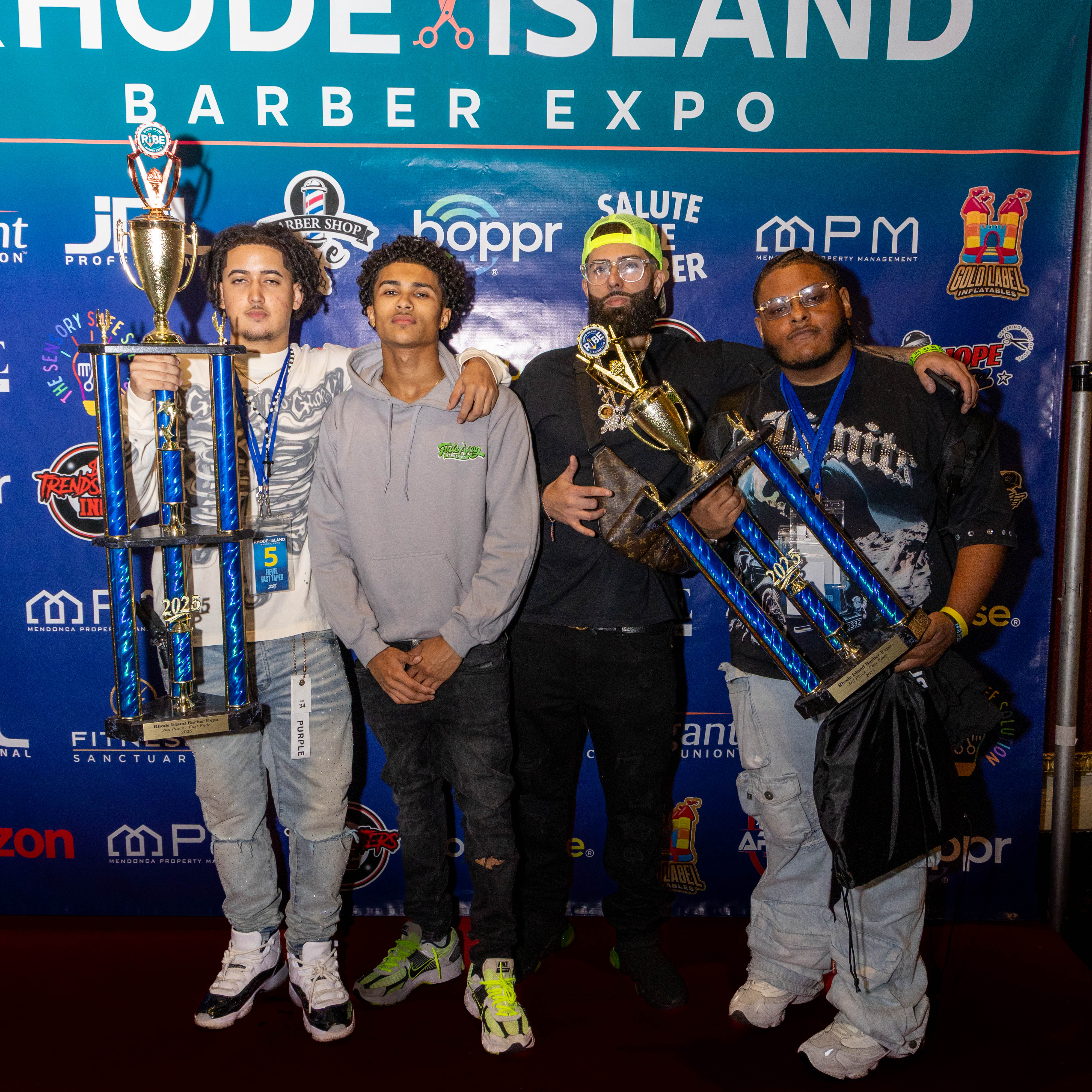 Competition winners holding trophies at Rhode Island Barber Expo