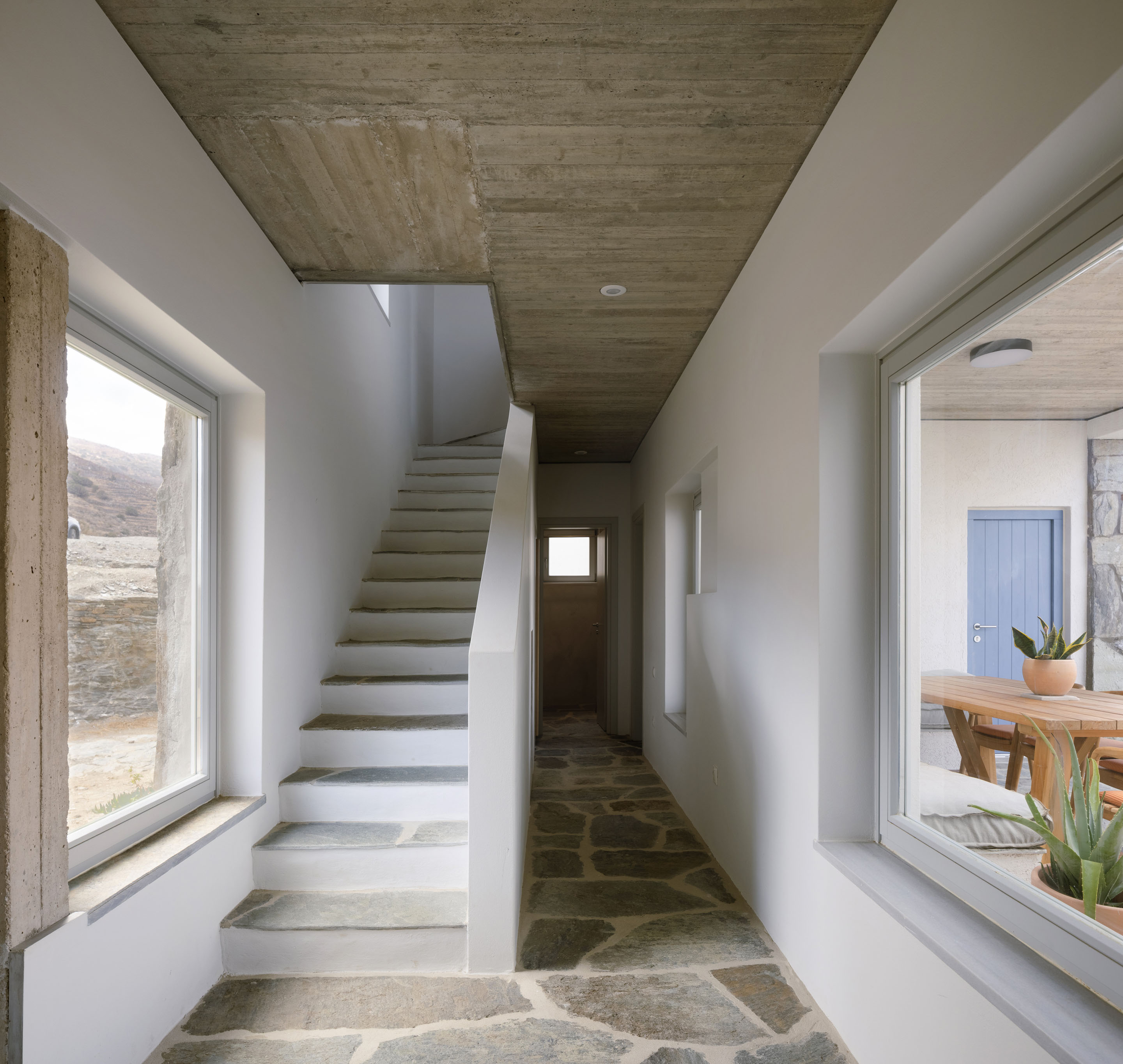 Interior hallway with stone floors and concrete ceiling