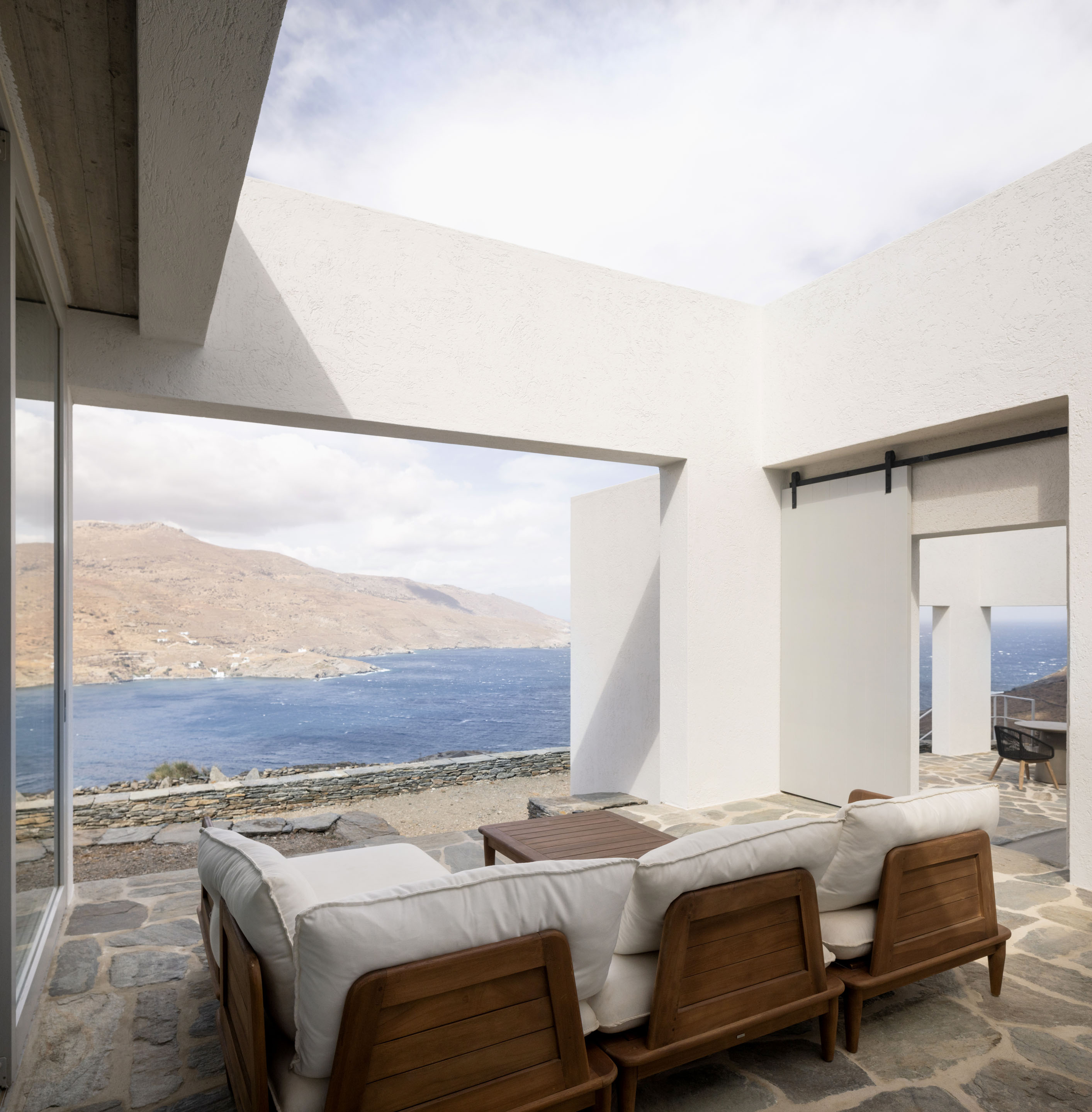 Outdoor terrace seating with panoramic sea views over Korthi Bay