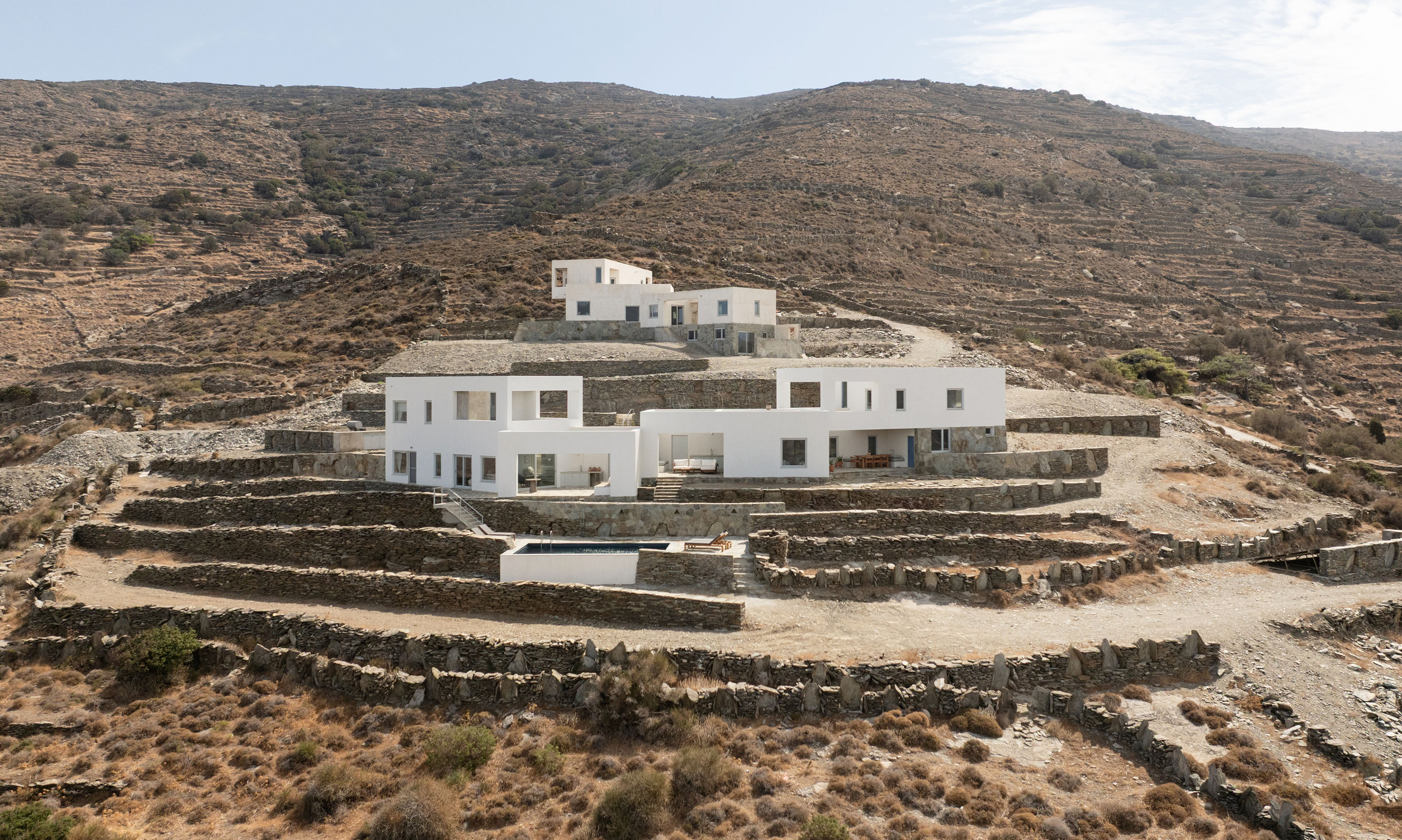 Full complex with terraced stone walls and pool