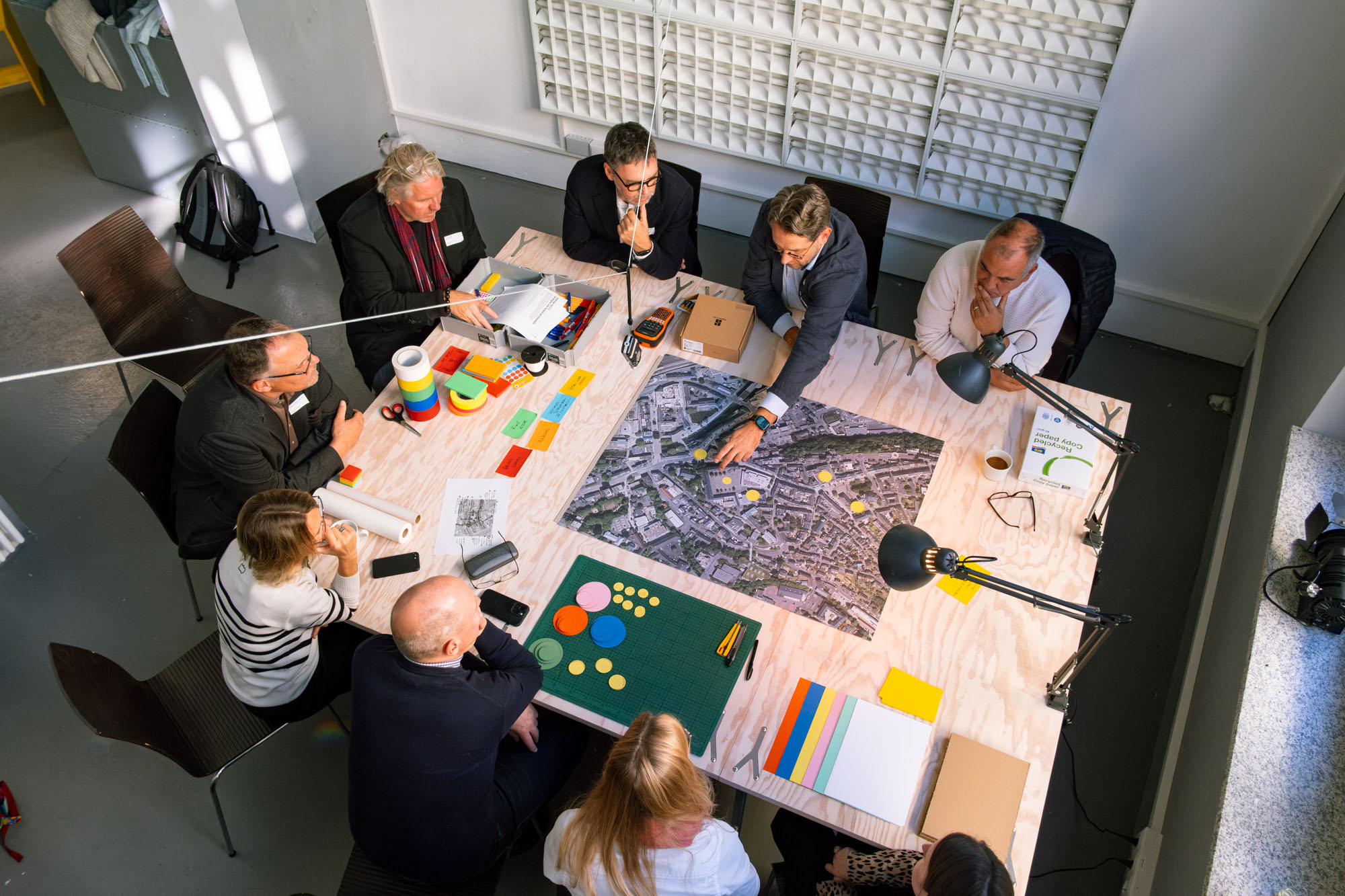 Workshop participants collaborating around a map during a planning session