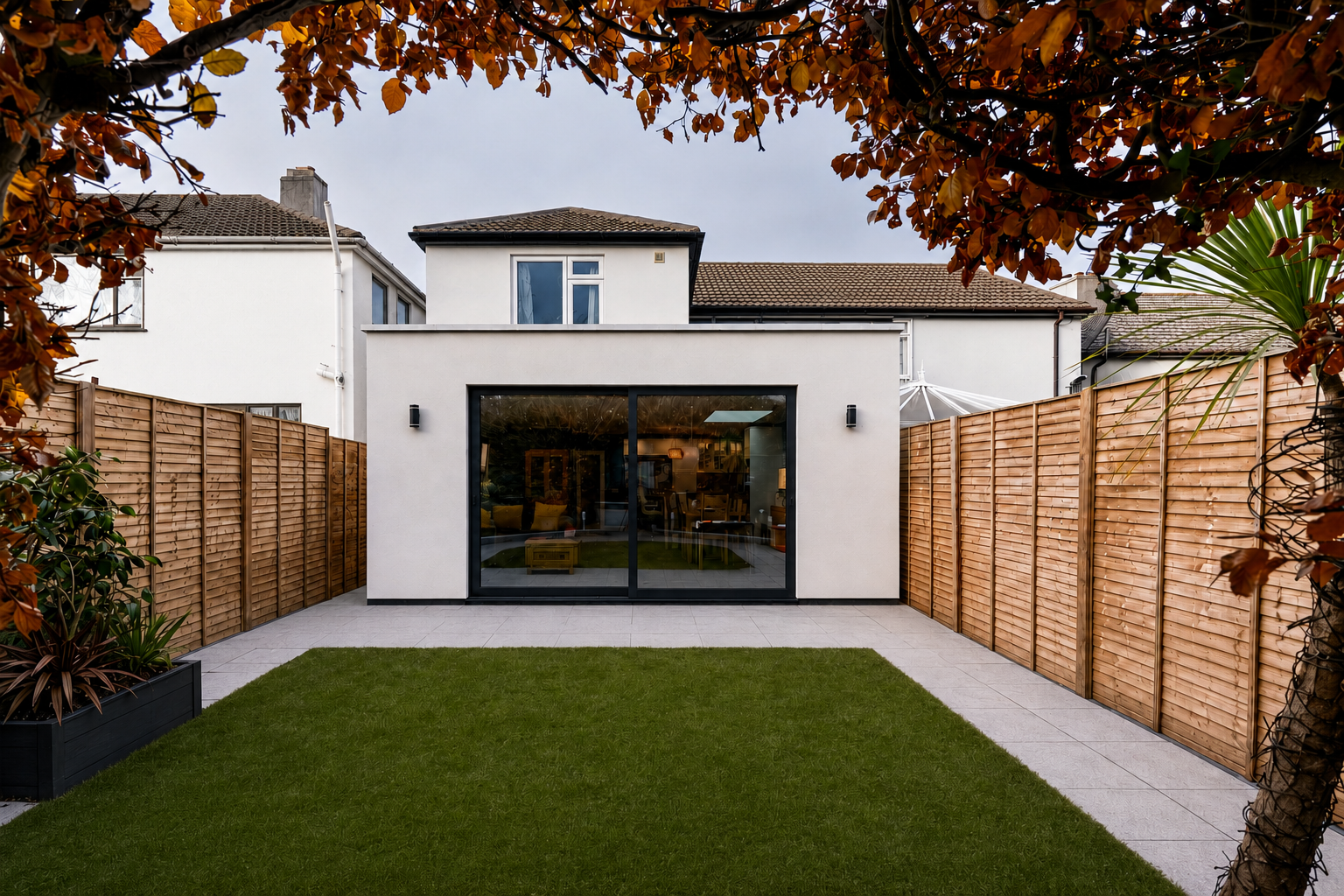 Rendered flat-roof extension with sliding doors in Hertfordshire