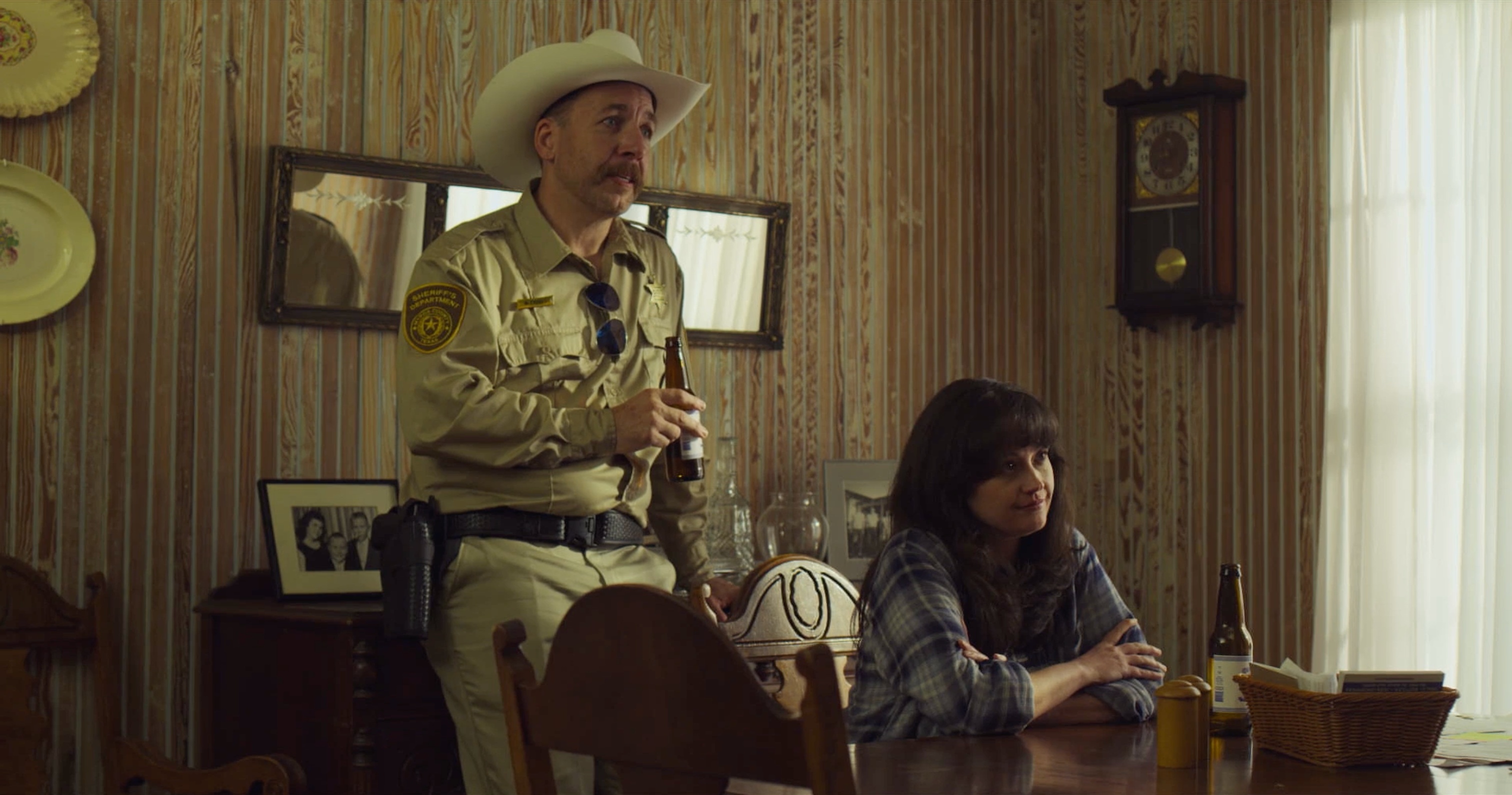 A sheriff visits Charlie and Dee at home