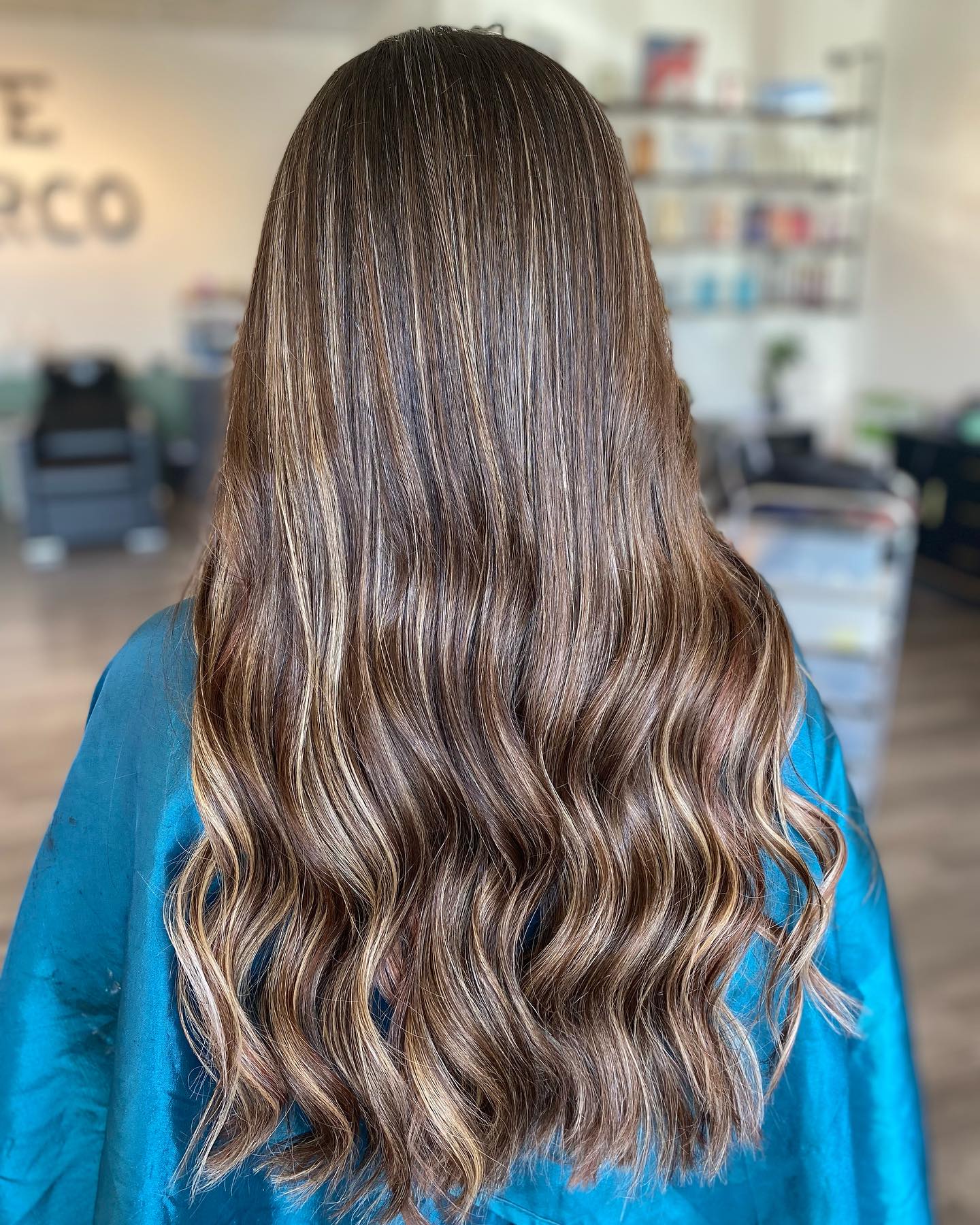 Brunette balayage back view inside The Hair Co. Salon