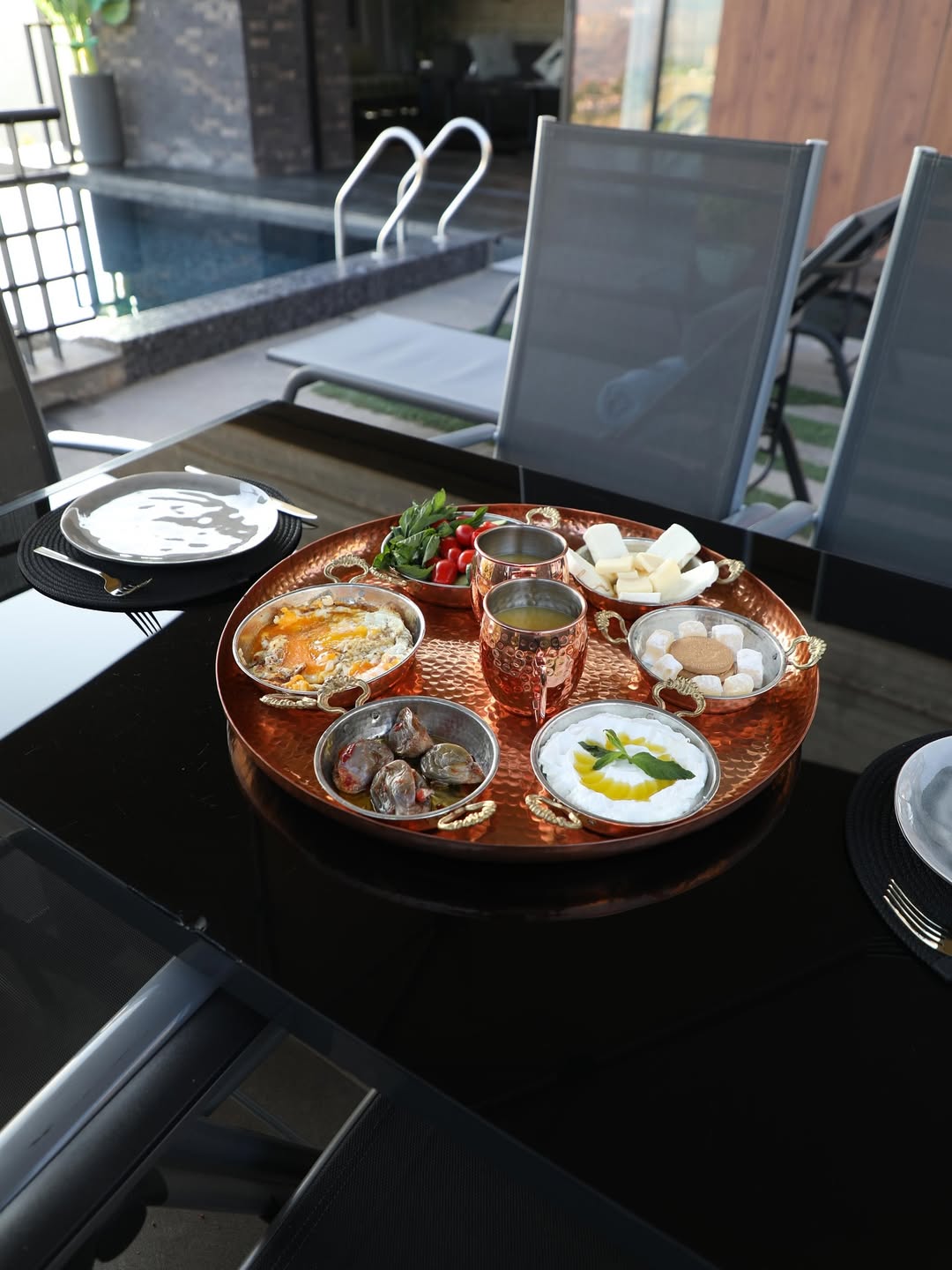 Traditional Lebanese breakfast served on copper tray poolside at Minus7
