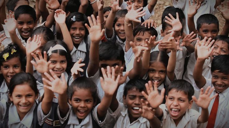 Schoolchildren raising their hands with excitement