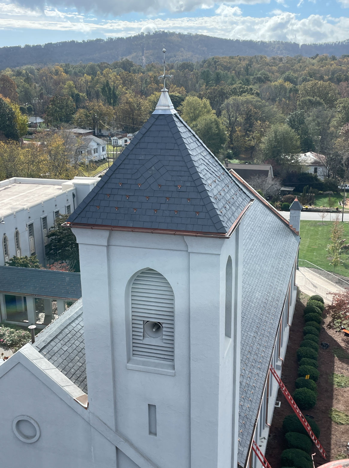 Professional slate roofing with mountain backdrop