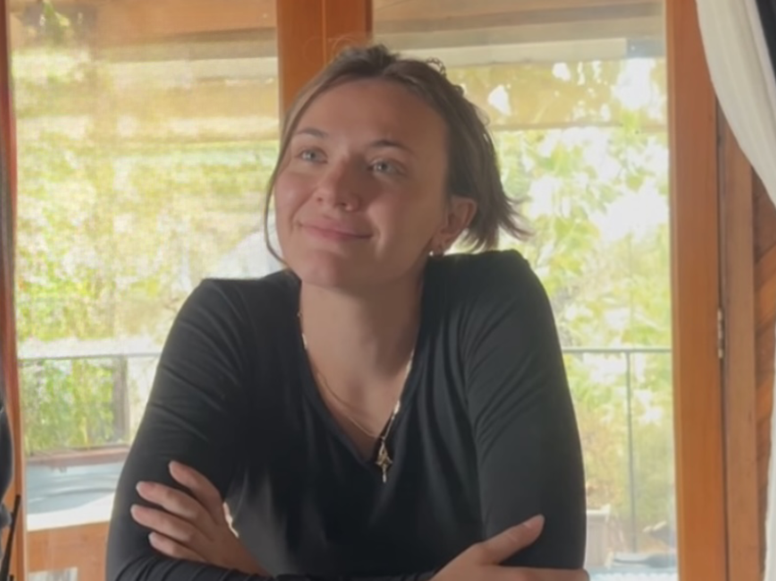 A person sitting by a window with natural lighting