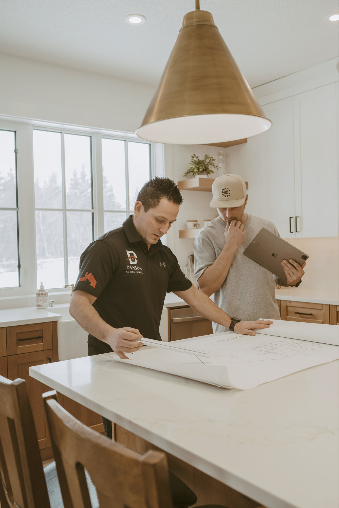 Cody Chikie reviewing blueprints with a client