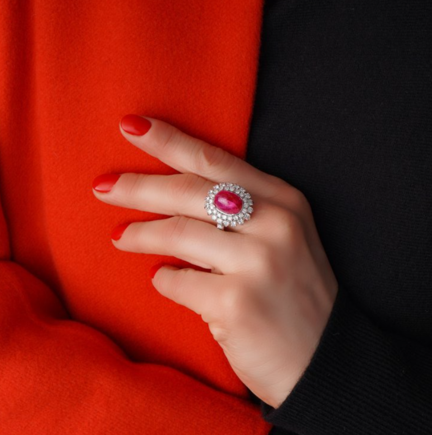 Ruby and diamond cluster ring on hand