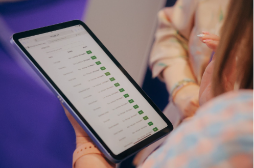 A judge at RCOG 2025 reviewing their assigned submissions on an iPad