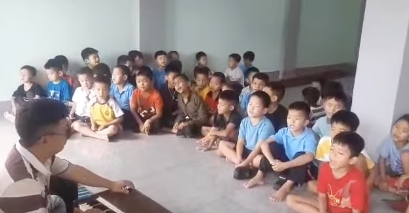 Children participating in indoor activities and music class
