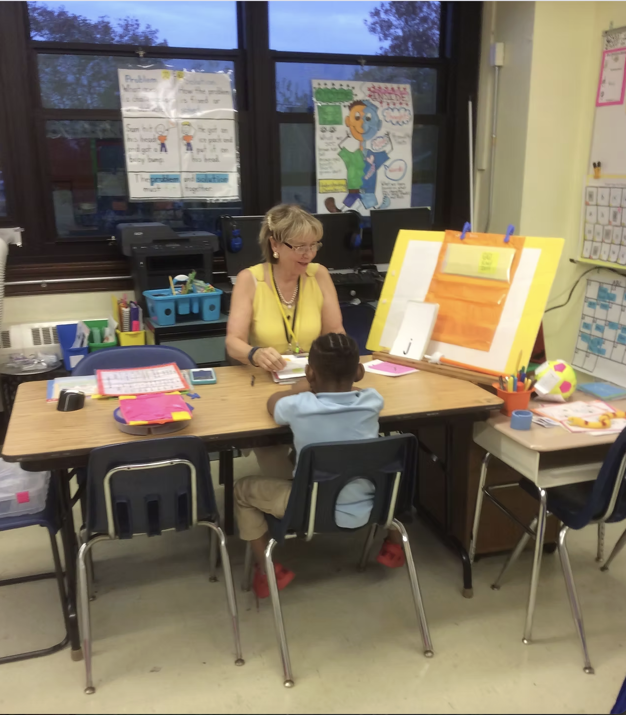 Reading specialist working one-on-one with a student in a classroom setting