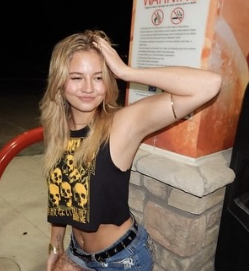 Blonde woman in Relentless top