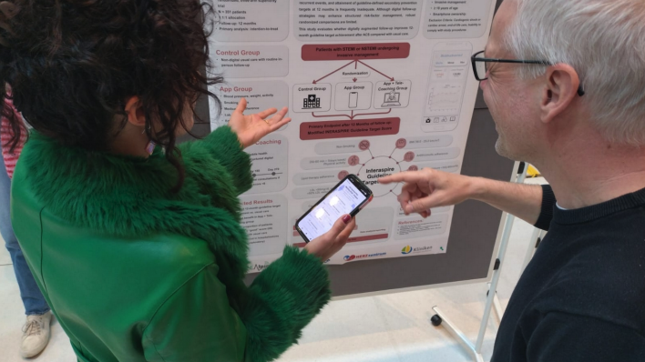A judge at the Life Science PhD Meeting 2026 scoring a poster presentation using InstaJudge on their phone