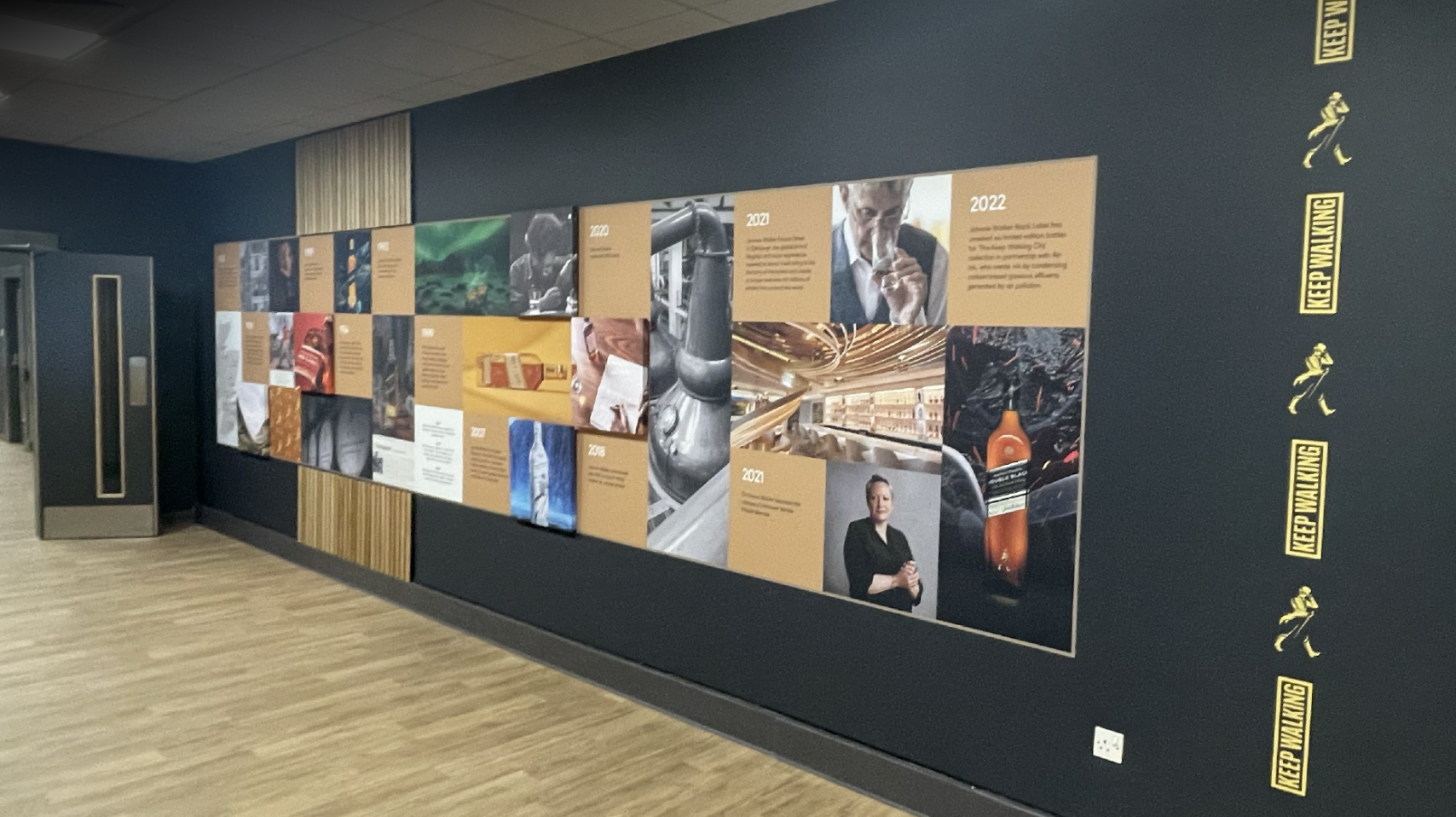 Johnnie Walker brand timeline wall with Keep Walking icons