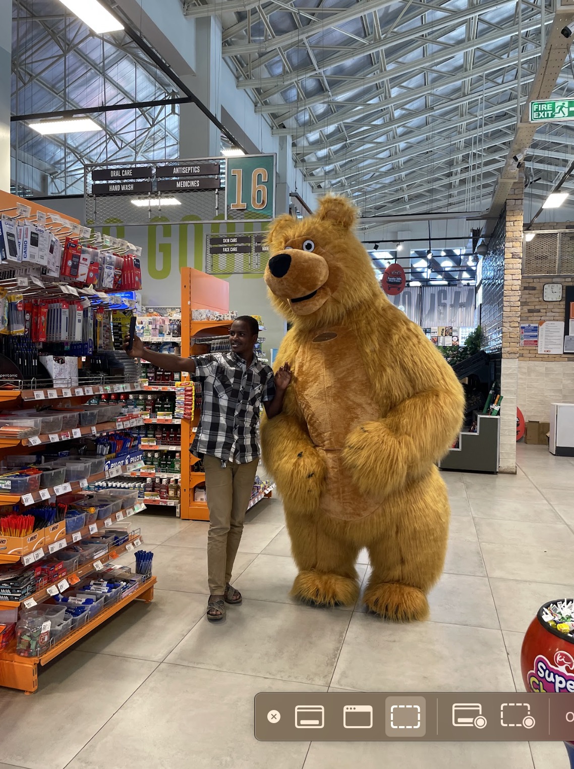 Bear mascot at Naivas supermarket with shopper