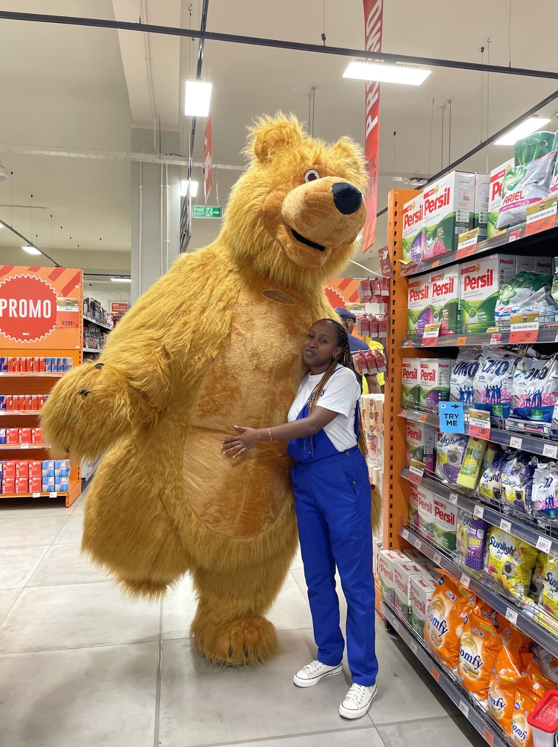 Giant bear mascot with staff in a supermarket