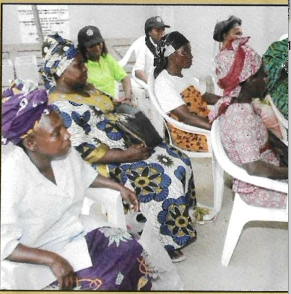 Widows seated together during the indoor visitation