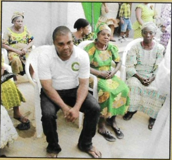 The Director sits among elderly widows, sharing in companionship