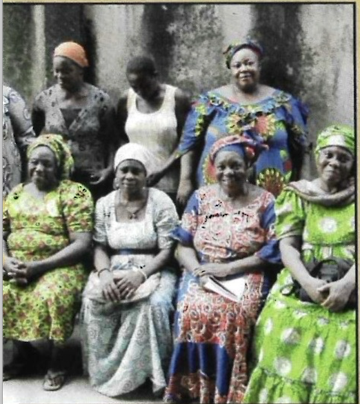 Widow beneficiaries seated and standing together