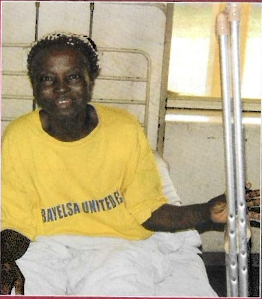 Volunteer assisting patient with new wheelchair