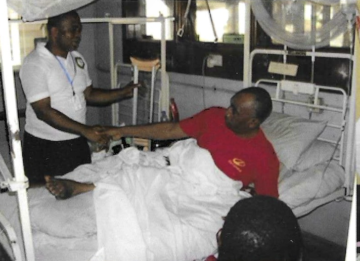 Volunteer with patient as another team member looks on